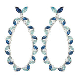 Sterling Silver Rhodium Plated Hanging Oval Shaped Earrings With Blue And Clear CZ