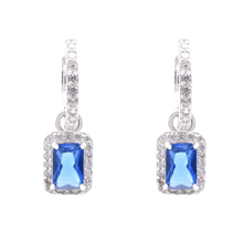 Load image into Gallery viewer, Sterling Silver Rhodium Plated Dangling Micro Pave Emerald Cut Blue And Clear CZ Huggie Earring