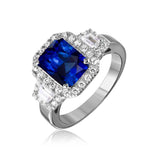 Sterling Silver Rhodium Plated Emerald Cut Center Ring With Blue Sapphire And CZ Stones