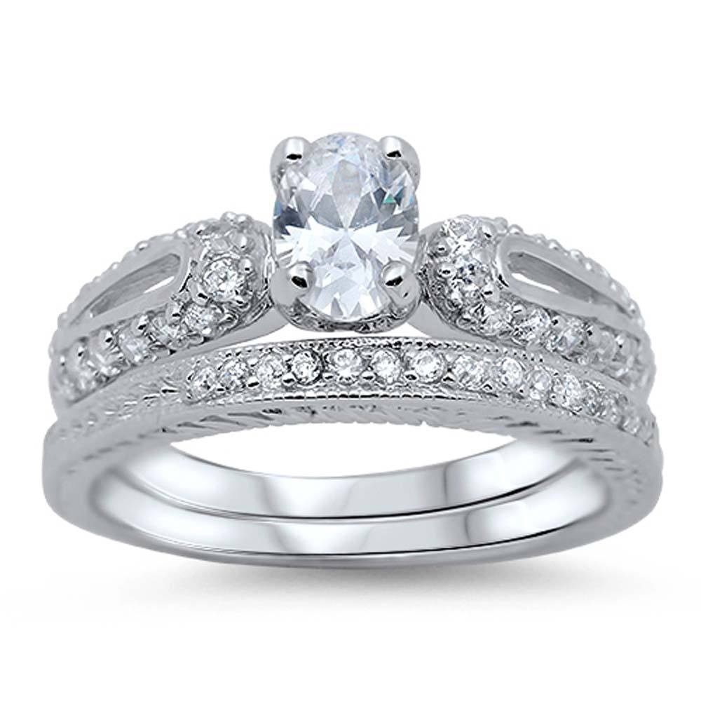 Sterling Silver Pave Set Clear CZ Fancy 2 Piece Engagement Ring Set with a 4 Prong Set Oval Cut Clear CZ in the CenterAnd Ring Face Height of 9MM and Ring Band Width of 3MM