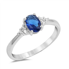 Load image into Gallery viewer, Sterling Silver Clear CZ Fancy Ring with a 4 Prong Set Oval Blue Sapphire CZ in the CenterAnd Ring Face Height of 7MM